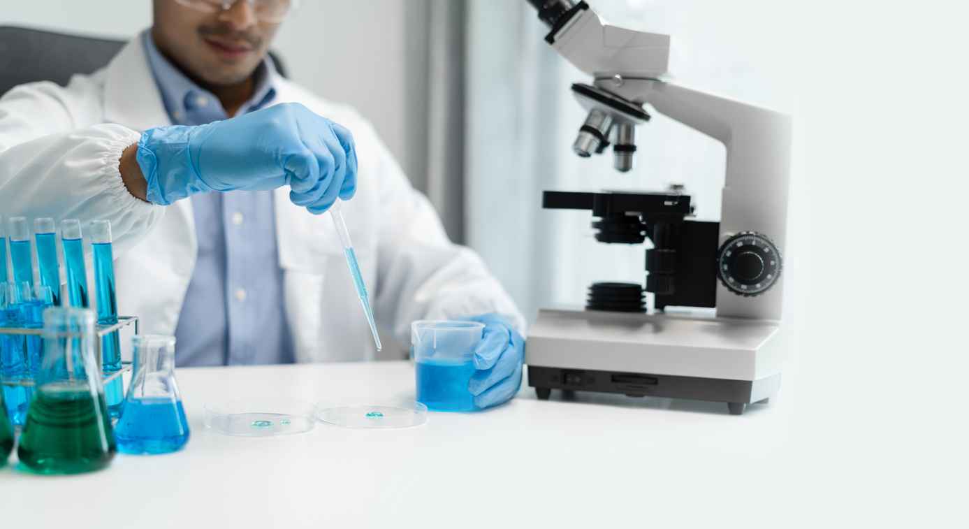 Science and medicine, scientist analyzing and dropping a sample into a glassware, experiments containing chemical liquid in laboratory on glassware, innovative and technology.