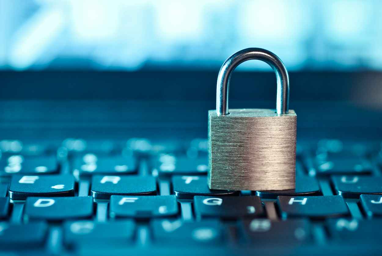Computer security concept; a lock sitting on a laptop's keyboard