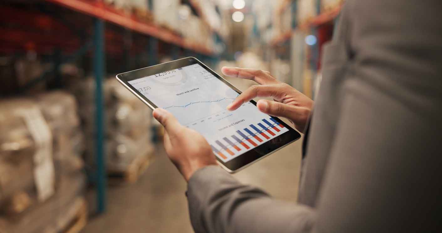 Person, hands or logistics with tablet screen for analytics, graph or chart data at storage warehouse. Closeup, distributor or analyst with technology for inventory expenses, income or stock cashflow