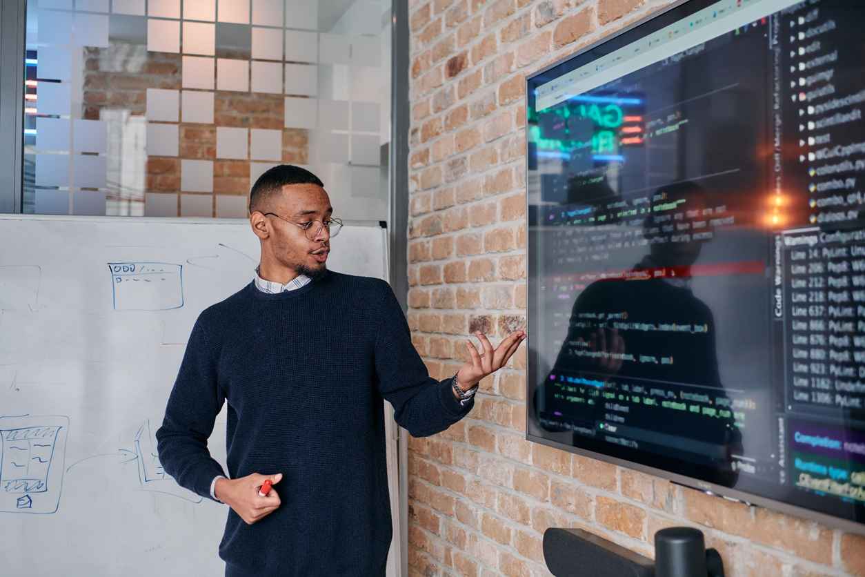 African American businessman delivers a compelling presentation of his business strategy to his colleagues, fostering collaboration and forward thinking.