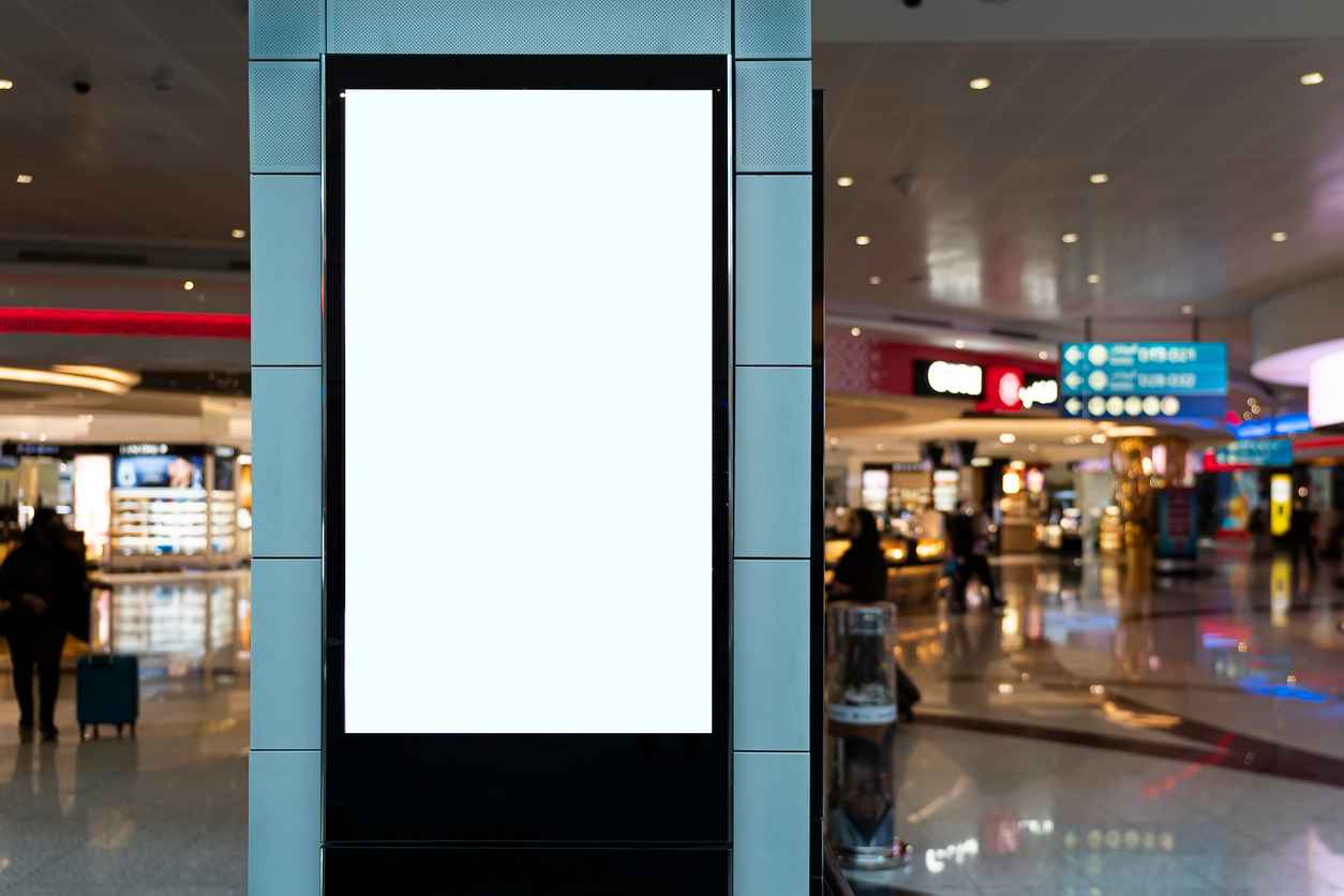 Blank mock up of vertical street poster billboard on Airport Background with plane passengers. an advertising banner in a shopping center on a blurry background.
