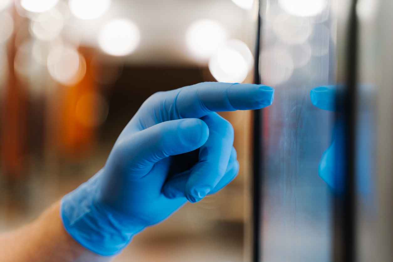 Close up hand in rubber disposable glove types on touch screen, uses preventive measures during coronavirus pandemic, buys things in supermarket with self service, avoids direct contact with surface