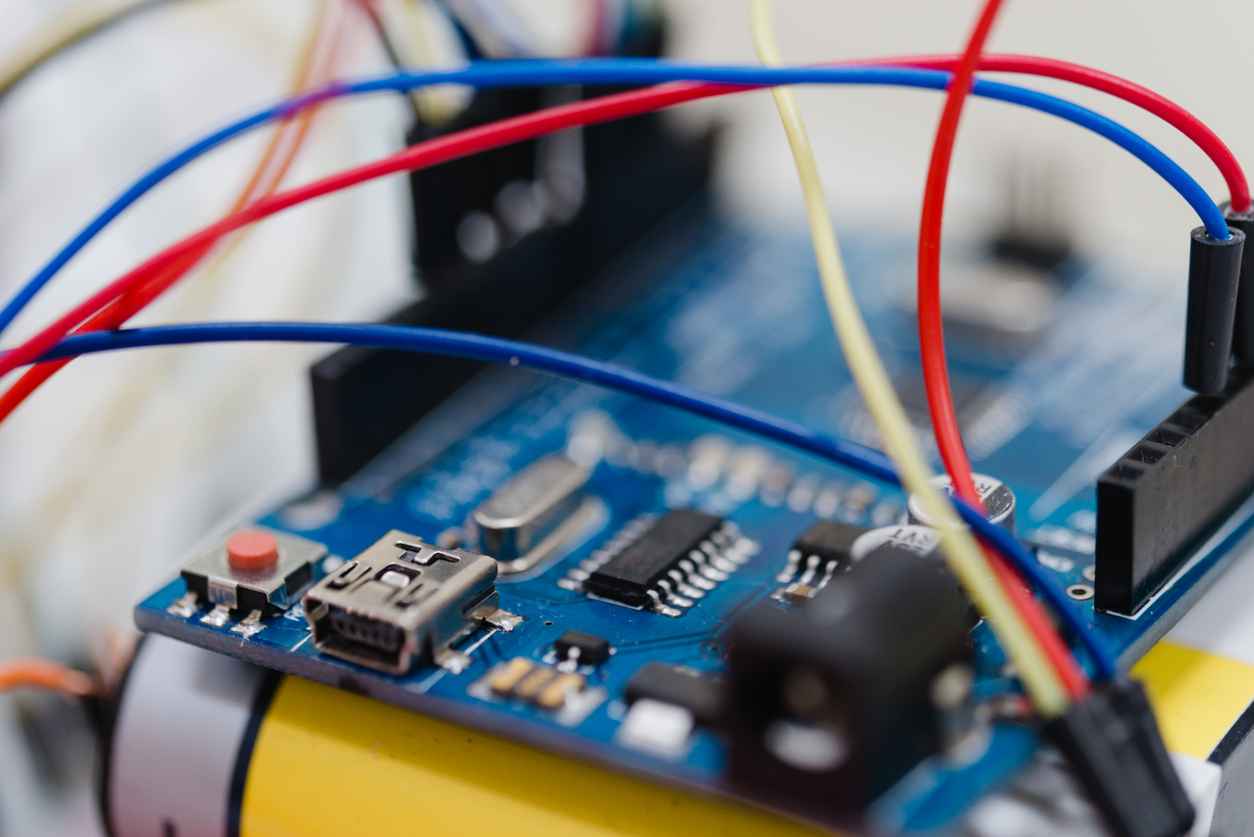 Macro photo of a little embedded systems motherboard with attached cables