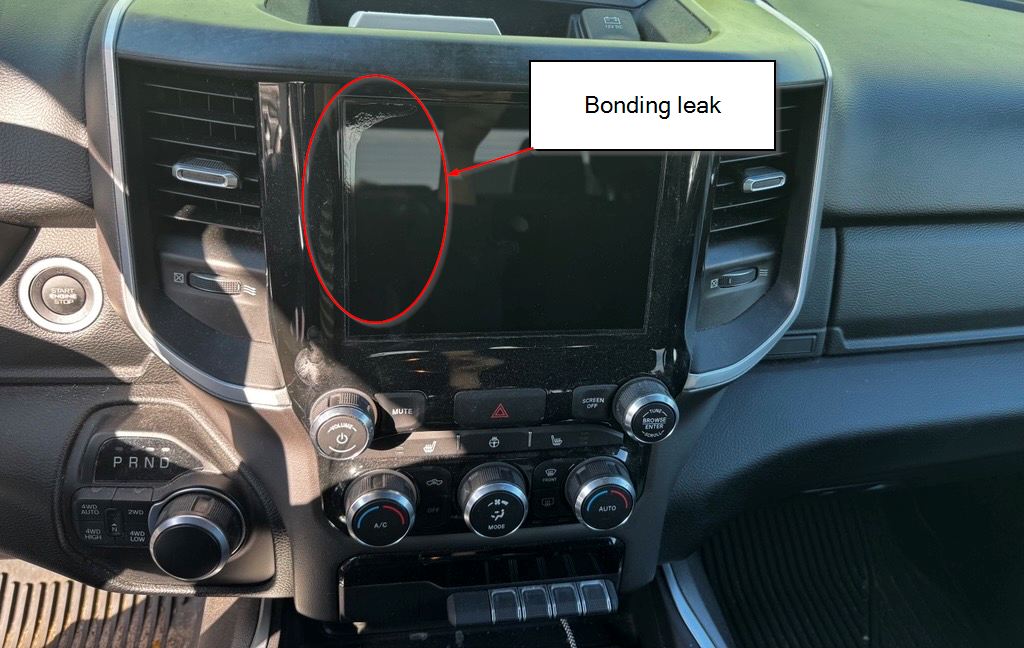 Straight-on view of the in-vehicle display in Scott Makboulian's truck, with liquid optical bonding leakage along its top-left corner and left edge