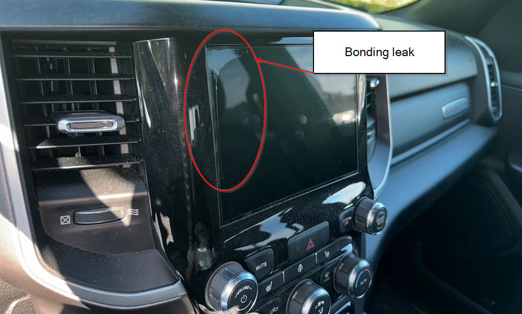 Angled view of the same display, with the liquid optical bonding leak running down its left edge